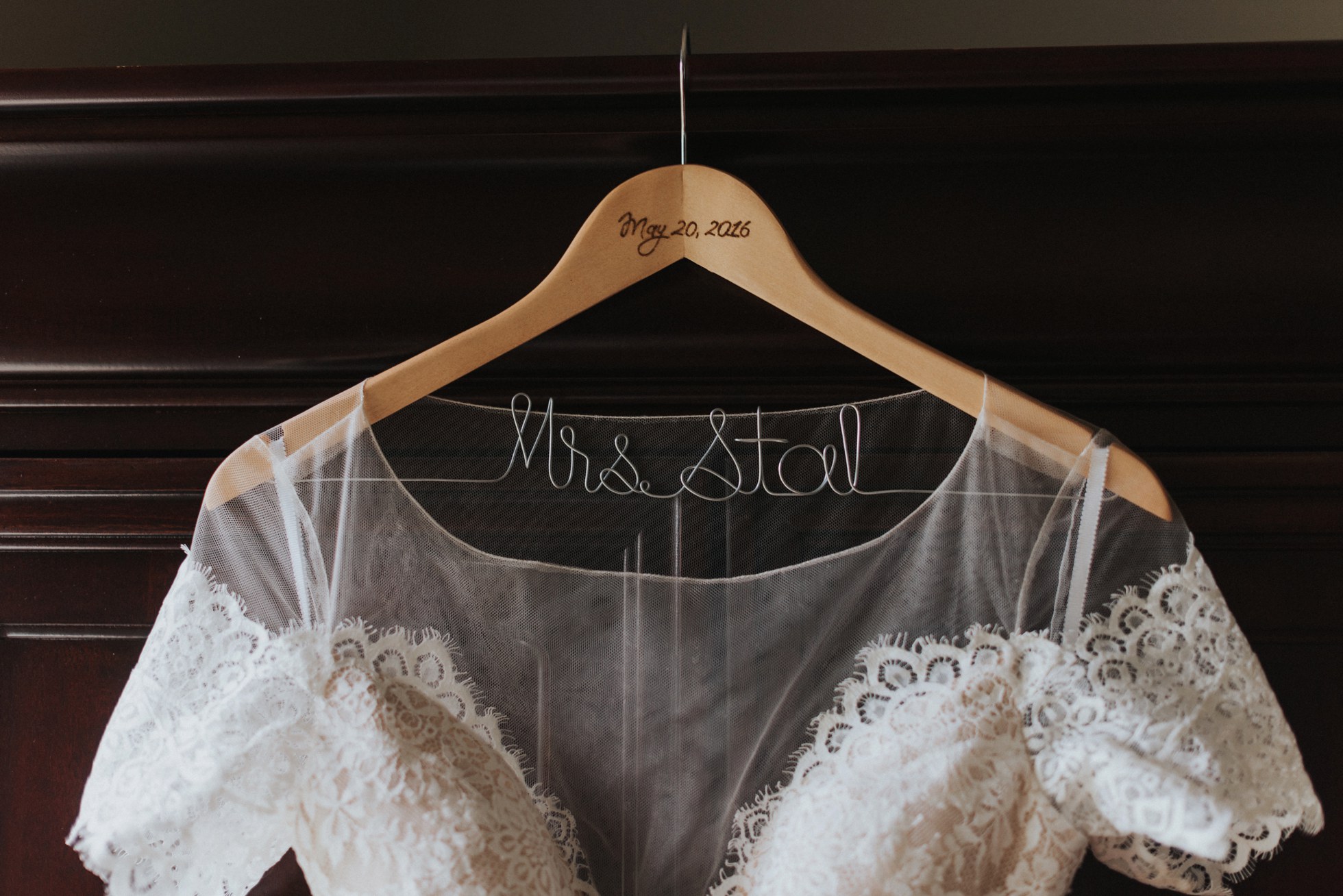 brides name on hanger of wedding dress