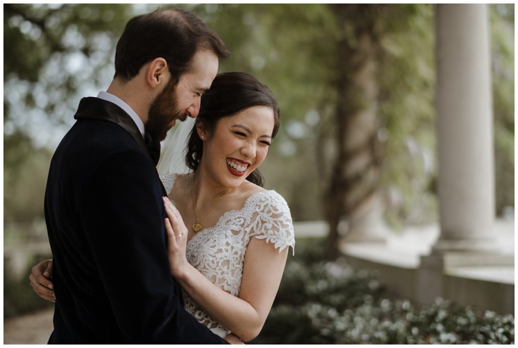 bride laughs at something her groom says during their First Look